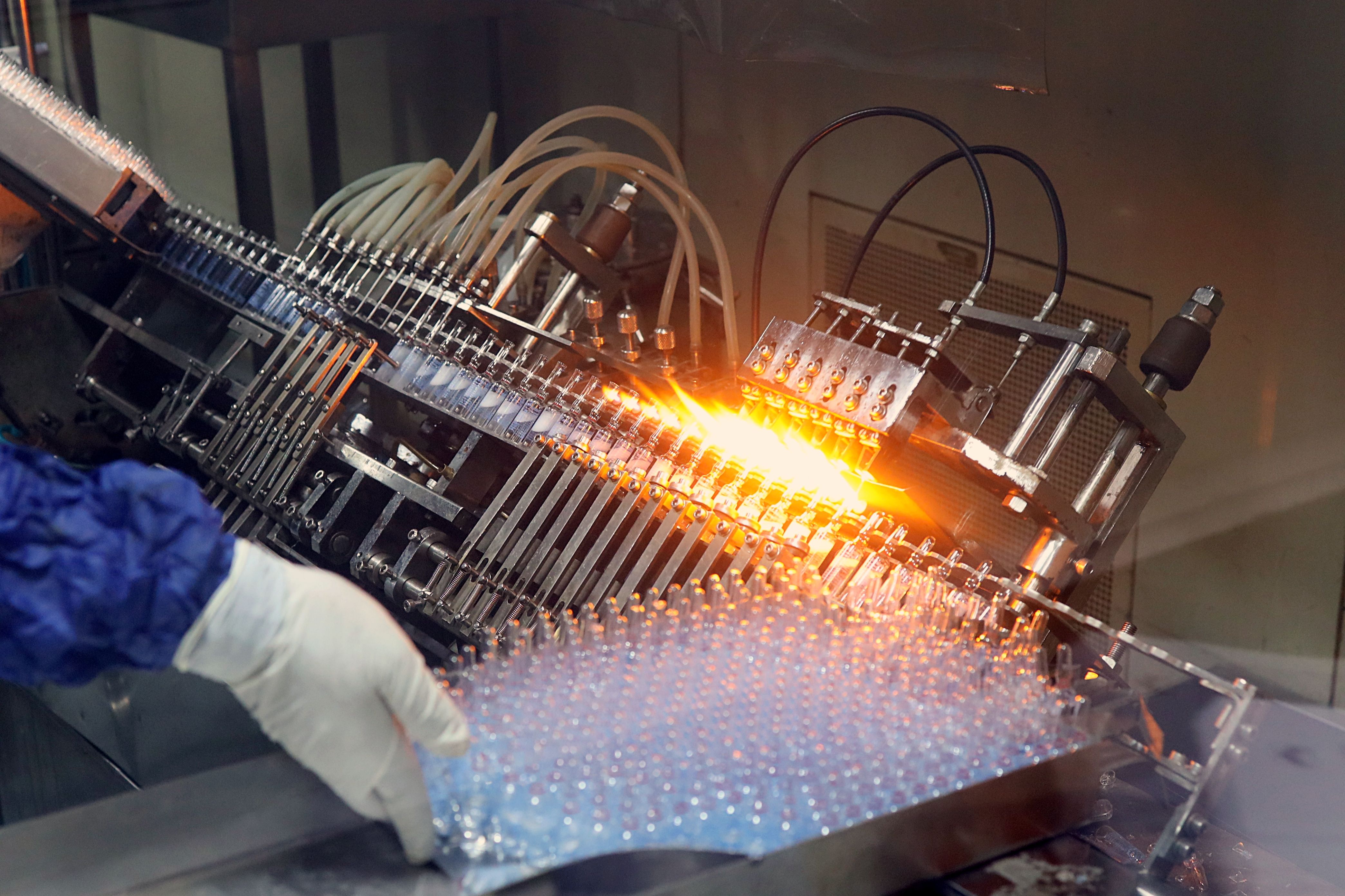 Close-up of an ampoule filling and sealing machine on a pharmaceutical production line